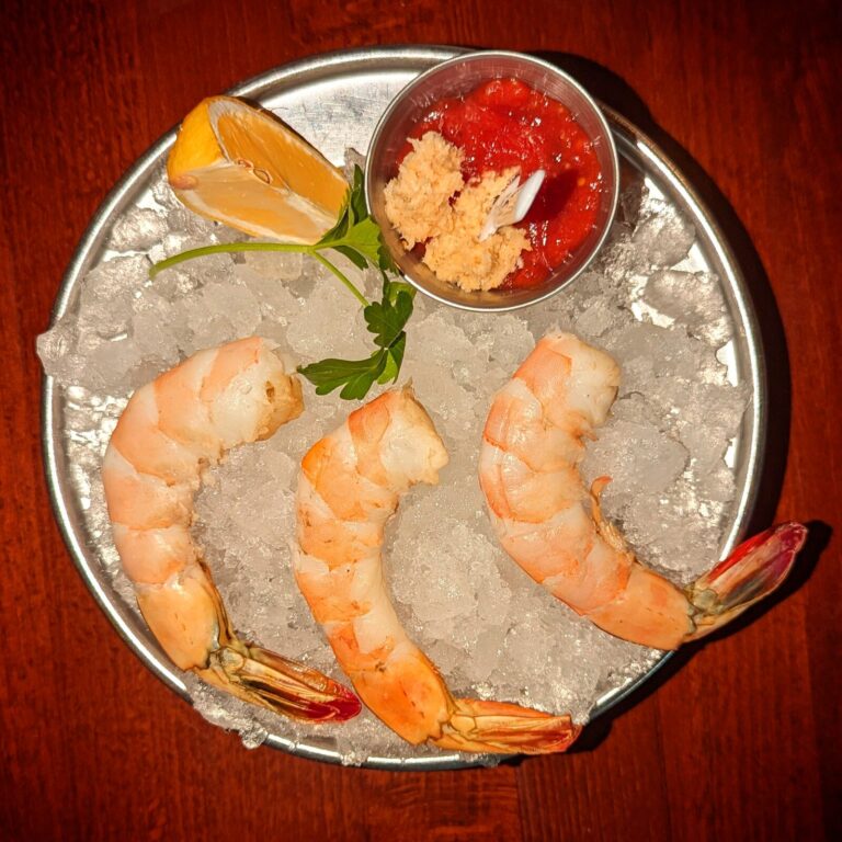 Shrimp cocktail on crushed ice with cocktail sauce, horseradish and lemon (representative photo)